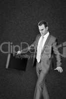 Composite image of businessman walking with his briefcase