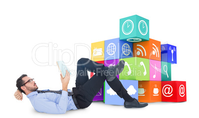 Composite image of businessman lying on the floor while reading