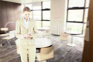 Composite image of businesswoman using her mobile phone