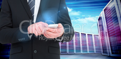 Composite image of businessman sending a text message