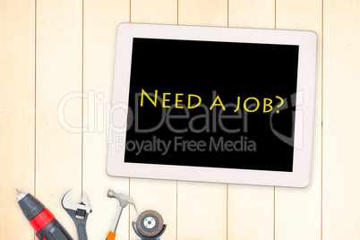 Need a job? against tools and tablet on wooden background