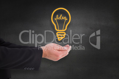 Composite image of businessman holding something with his hands