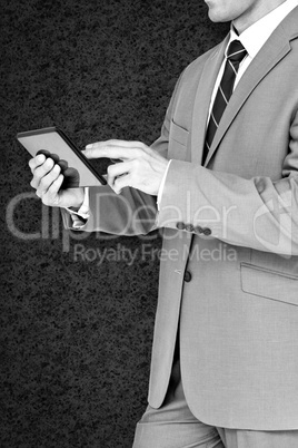 Composite image of businessman using tablet pc