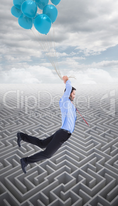 Composite image of businessman flying with balloons