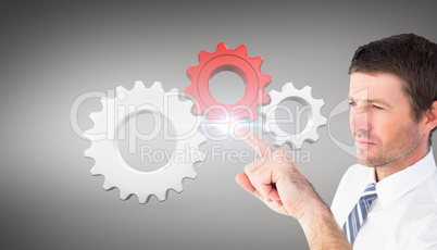 Composite image of businessman pointing with his finger