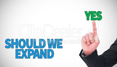 Composite image of unsmiling businessman pointing his finger
