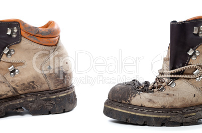 Old dirty hiking boots on white background