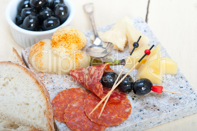 mix cold cut on a stone with fresh pears