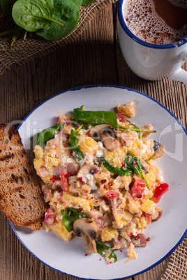 Scrambled eggs with tomatoes and spinach