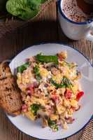 Scrambled eggs with tomatoes and spinach