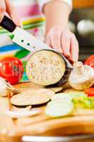 Woman's hands cutting aubergine eggplant