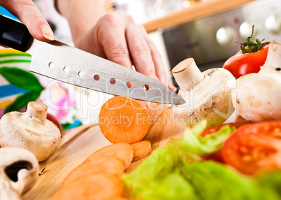 Woman's hands cutting vegetables