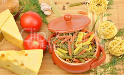 pasta, cheese and spices on the board