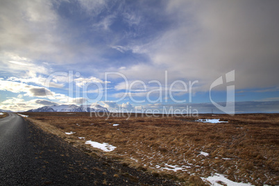 Snowy volcano landscape with dramatic clouds in Iceland