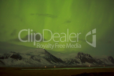 Northern lights with snowy mountains in the foreground