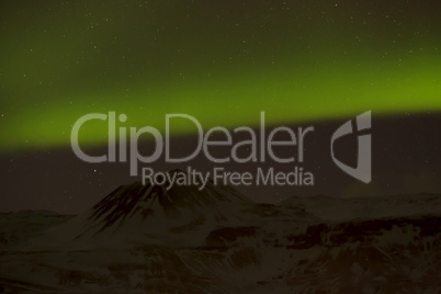 Northern lights with snowy mountains in the foreground