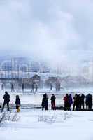 Visitors watching the eruption of a geyser in Iceland