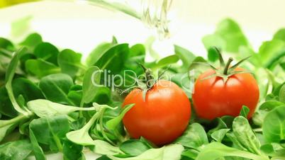 Olive oil pouring into salad