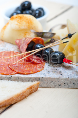 mix cold cut on a stone with fresh pears