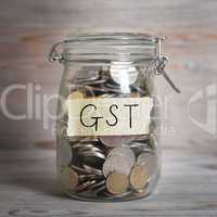 Coins in money jar with gst labe