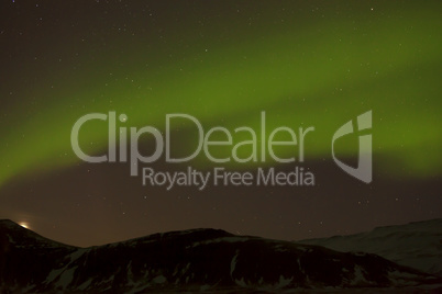 Northern lights with snowy mountains in the foreground