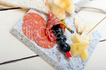 mix cold cut on a stone with fresh pears