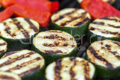 Zucchini and red pepper on a grill