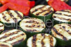 Zucchini and red pepper on a grill