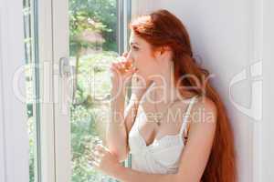 Thoughtful Pretty Woman Sitting at the Window