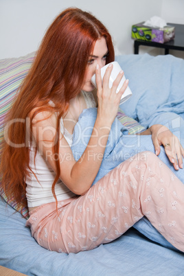 Pensive Woman Having an Early Coffee at her Bed