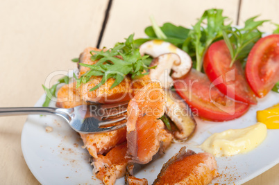 grilled samon filet with vegetables salad