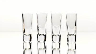 Row of Four Shot Glasses Lined Up