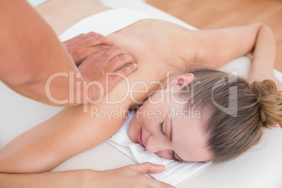 Physiotherapist doing back massage to his patient