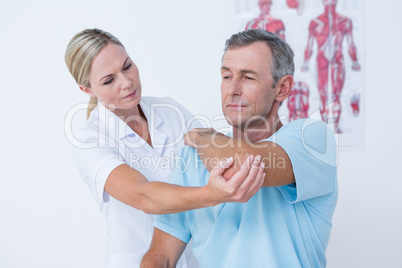 Doctor stretching a man arm