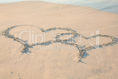 two hearts drawn in the sand