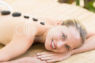 Beautiful woman receiving stone massage at spa center Beautiful woman receiving stone massage at spa center