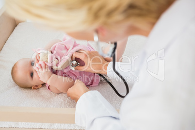 Beautiful cute baby girl with doctor with stethoscope