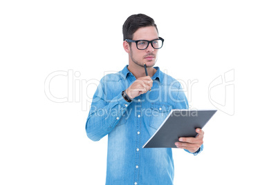 Serious geeky hipster holding book and pen