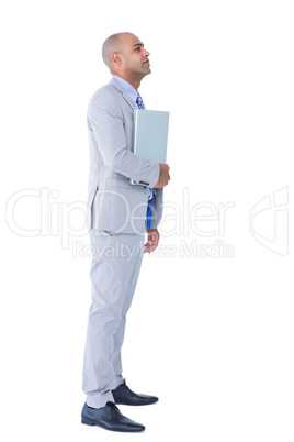 Unhappy businessman holding laptop computer