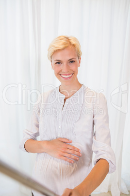 A portrait smiling blonde pregant