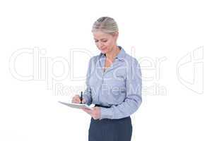 Businesswoman writing on clipboard