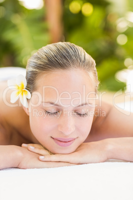 Peaceful blonde lying on towel