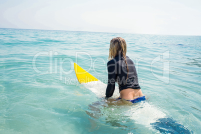 woman with a surfboard on a sunny day