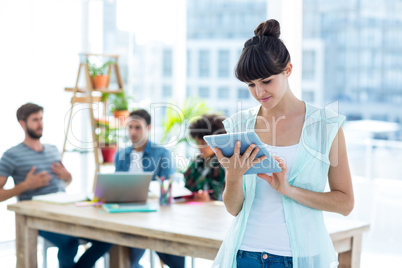 Smiling young businesswoman using tablet