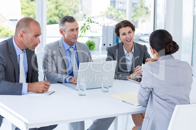 Interview panel listening to applicant