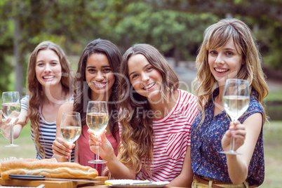 Happy friends toasing in the park