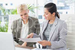 Businesswomen reading files