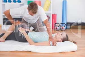 Woman stretching with her trainer