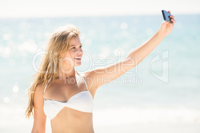 Happy pretty blonde taking selfie