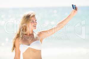 Happy pretty blonde taking selfie